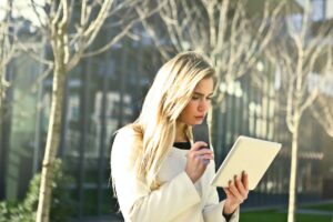 Photo by Andrea Piacquadio: https://www.pexels.com/photo/brown-haired-woman-holding-a-white-wireless-device-789703 --business